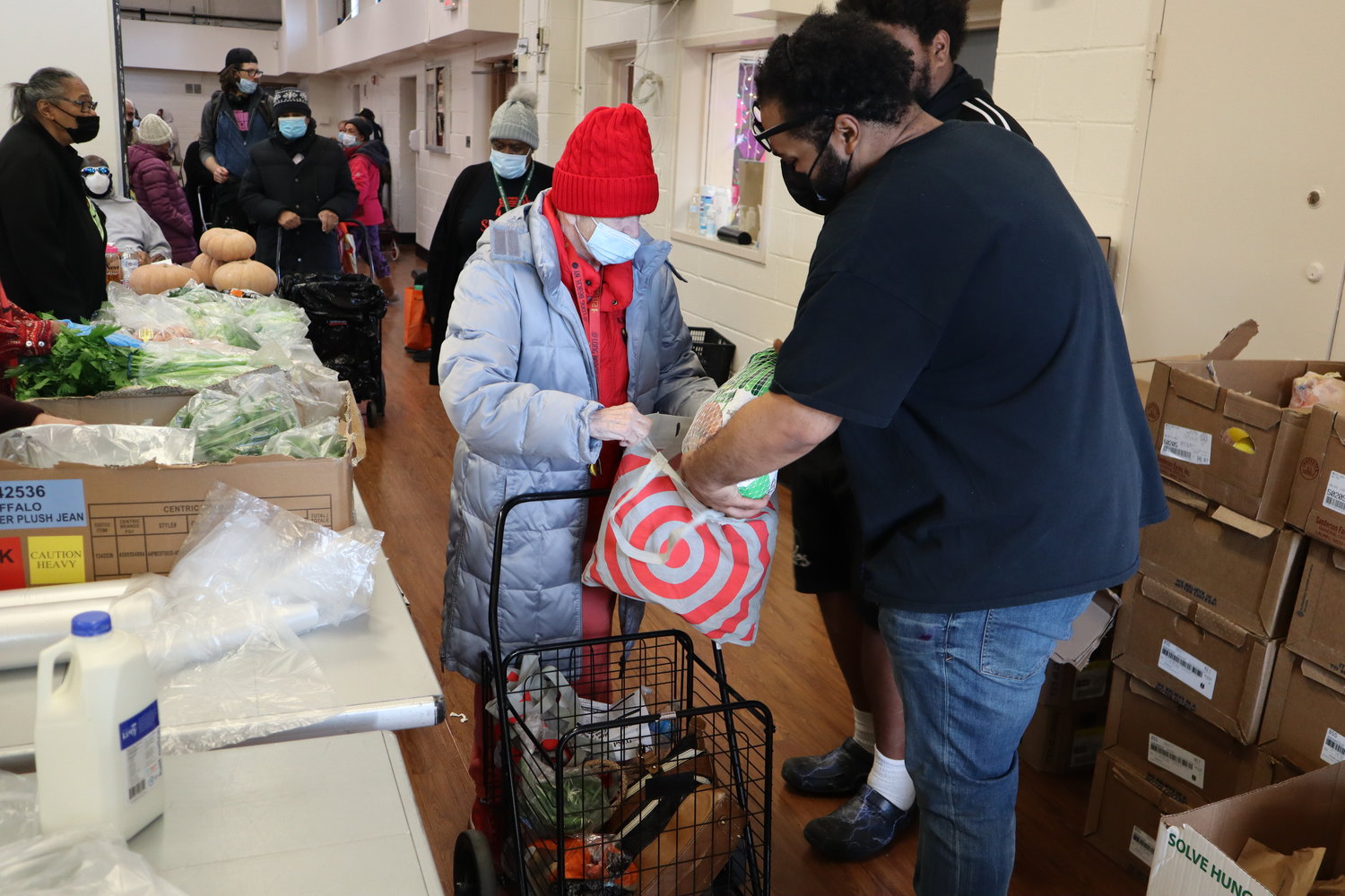 De’Juan Bacchas, 30, right, handed out turkeys and chickens donated by Island Harvest to patrons at the Dr. Martin Luther King Jr. Community Center food pantry on Friday, Nov. 18.